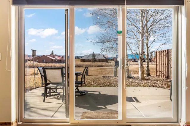 a view of a lake with table and chairs