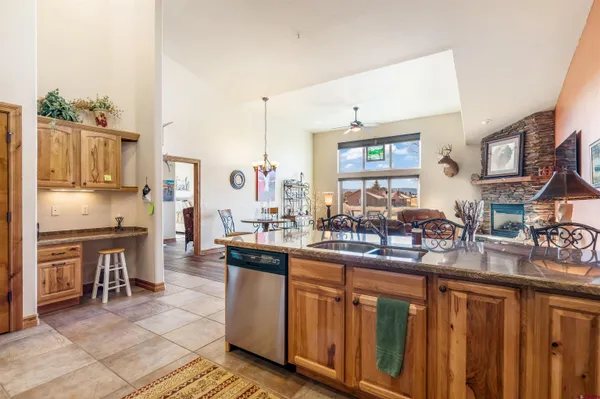 a kitchen with stainless steel appliances granite countertop a sink a stove and a refrigerator