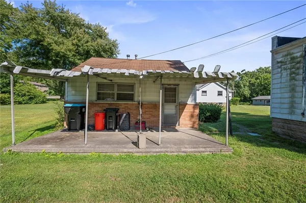a view of a house with backyard porch and sitting area