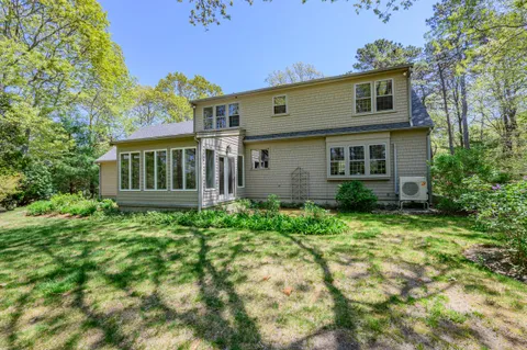 a view of a house with backyard and sitting area