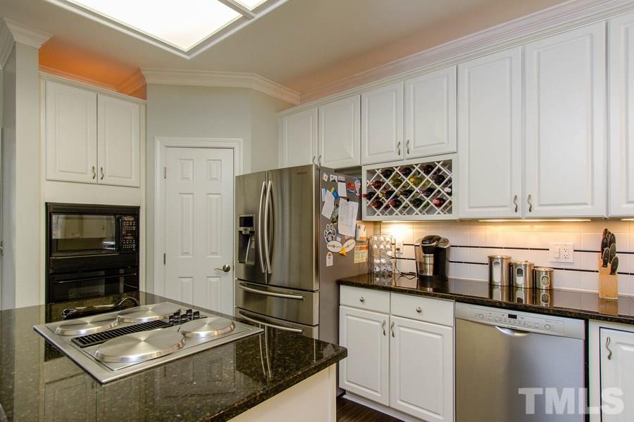 6324 Battleview Drive Raleigh, NC 27613 - Photo 11 of 25 a kitchen with refrigerator and cabinets