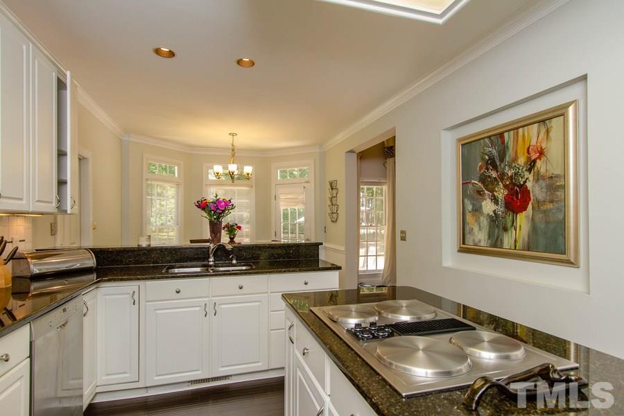 6324 Battleview Drive Raleigh, NC 27613 - Photo 13 of 25 a kitchen with stainless steel appliances a stove a sink and a refrigerator