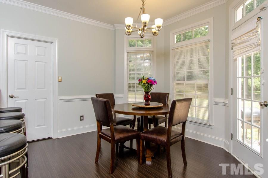 6324 Battleview Drive Raleigh, NC 27613 - Photo 14 of 25 a view of a dining room with furniture wooden floor and chandelier