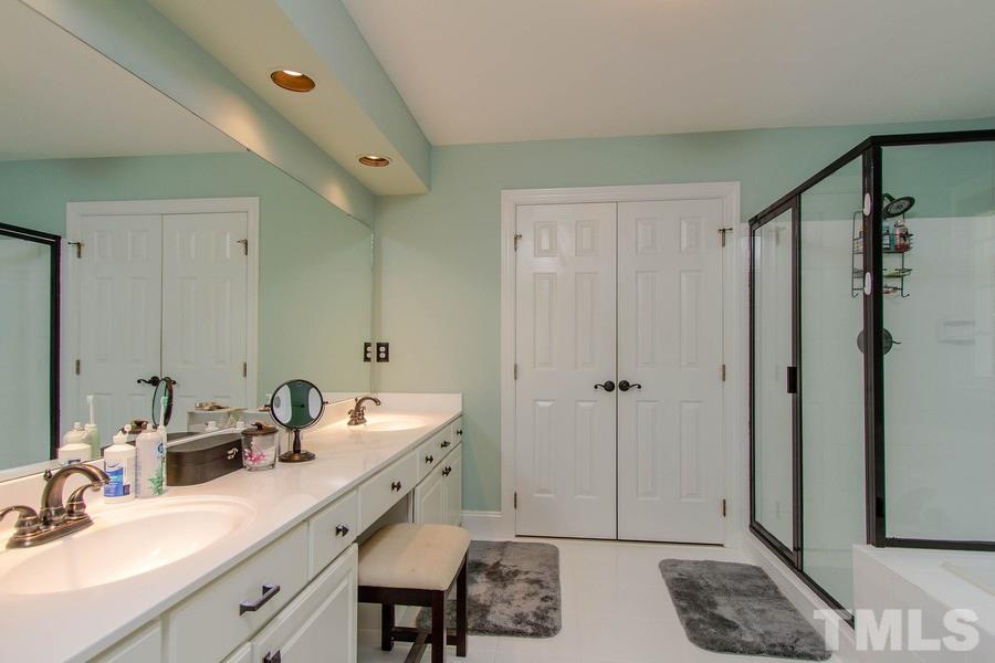 6324 Battleview Drive Raleigh, NC 27613 - Photo 16 of 25 a bathroom with a double vanity sink mirror and shower