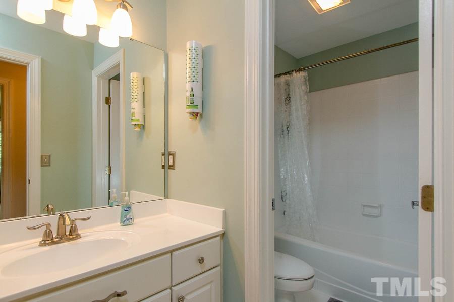 6324 Battleview Drive Raleigh, NC 27613 - Photo 18 of 25 a bathroom with a sink a toilet and shower