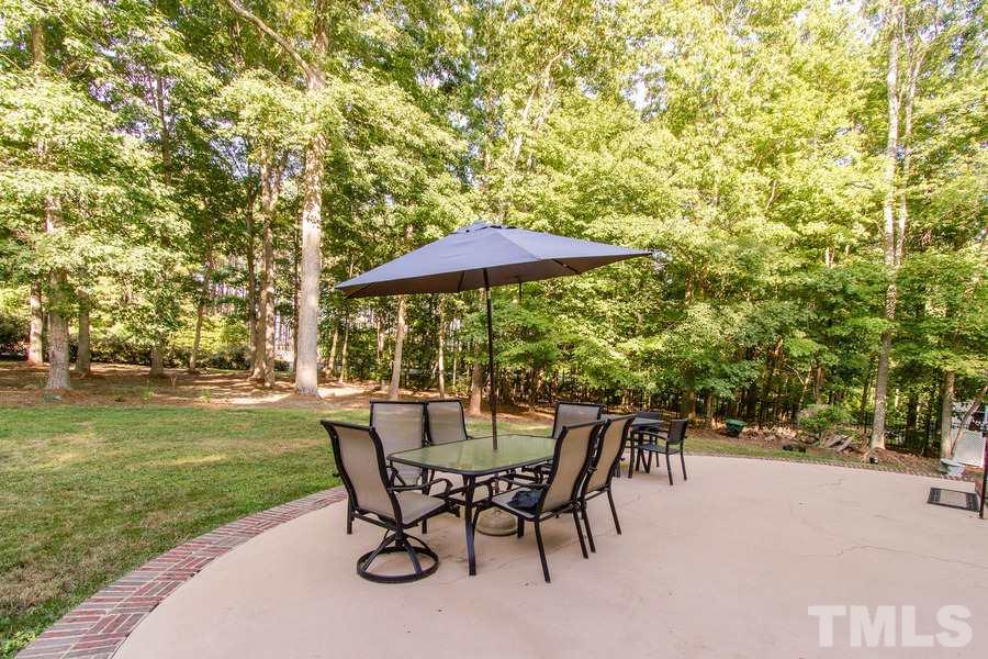 6324 Battleview Drive Raleigh, NC 27613 - Photo 22 of 25 a view of a backyard with a patio and garden