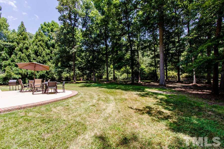 6324 Battleview Drive Raleigh, NC 27613 - Photo 23 of 25 a view of a swimming pool with a lawn chairs under an umbrella