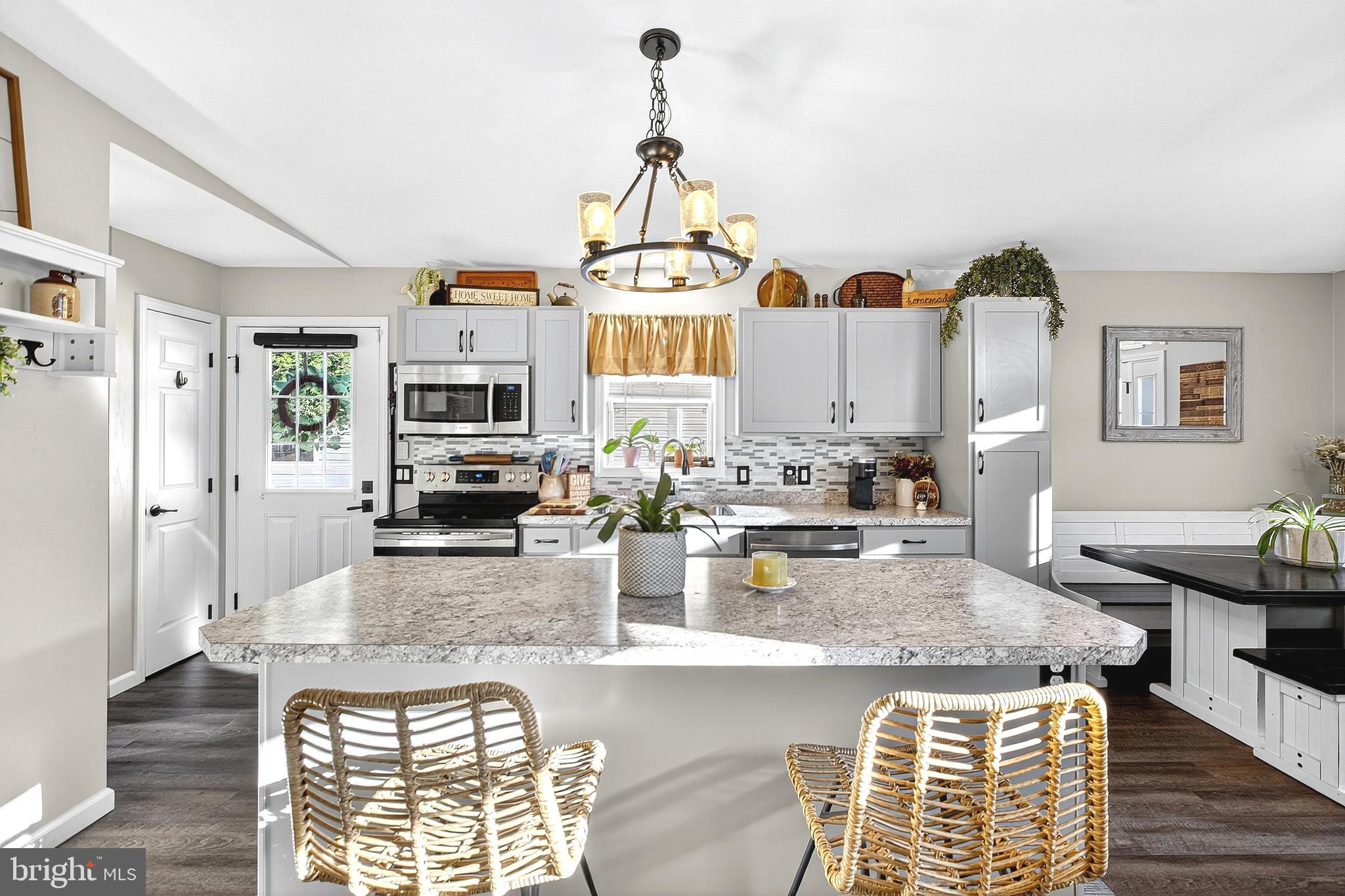 108 West Commerce Street Kenton, DE 19938 - Photo 19 of 48 a kitchen with stainless steel appliances granite countertop a stove and cabinets