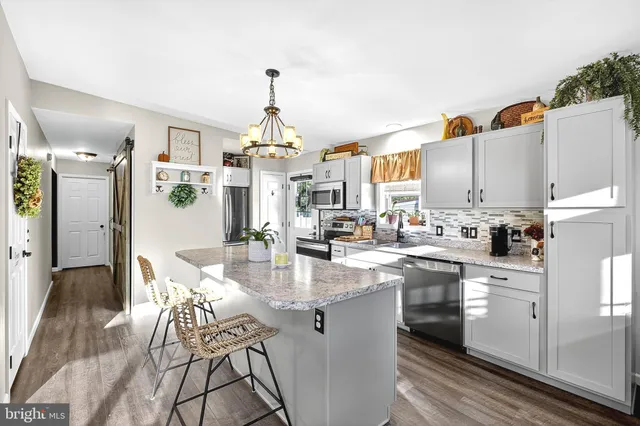 a front view of a house with a yard and trees