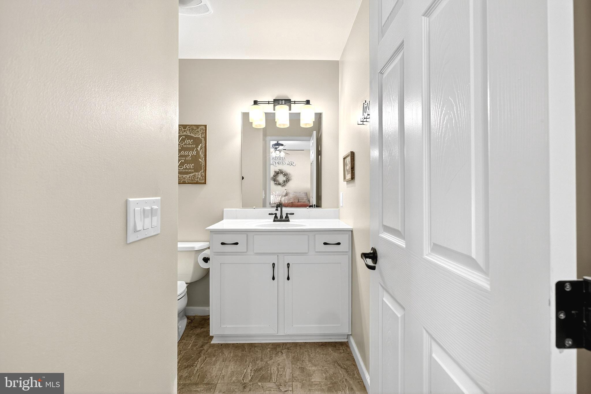 108 West Commerce Street Kenton, DE 19938 - Photo 29 of 48 a bathroom with a sink a mirror and a shower