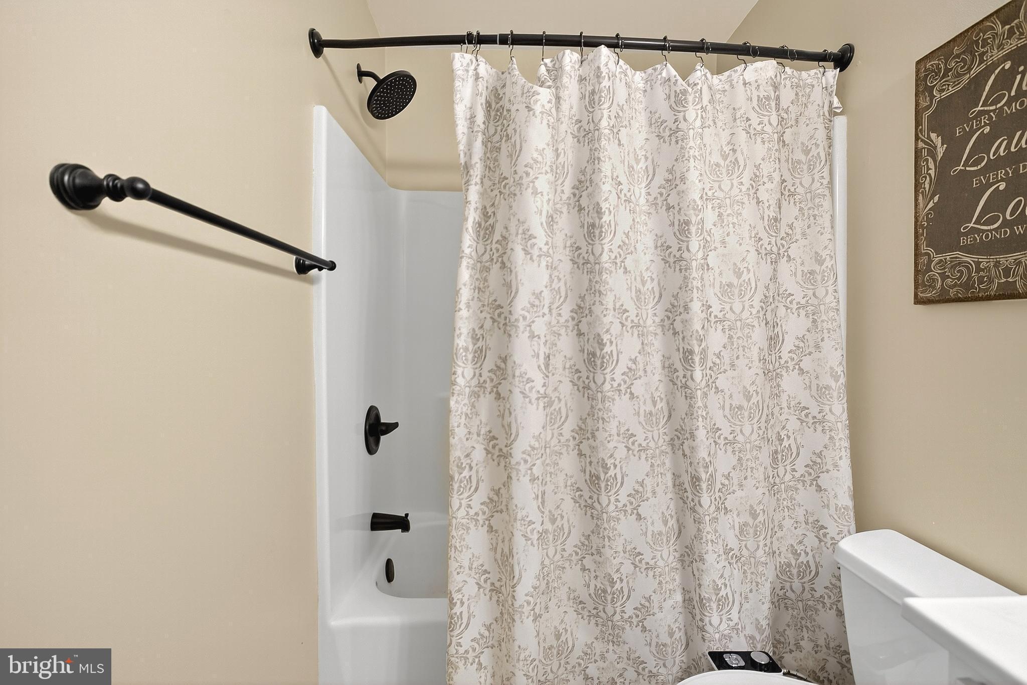 108 West Commerce Street Kenton, DE 19938 - Photo 30 of 48 a bathroom with a shower curtain and a toilet