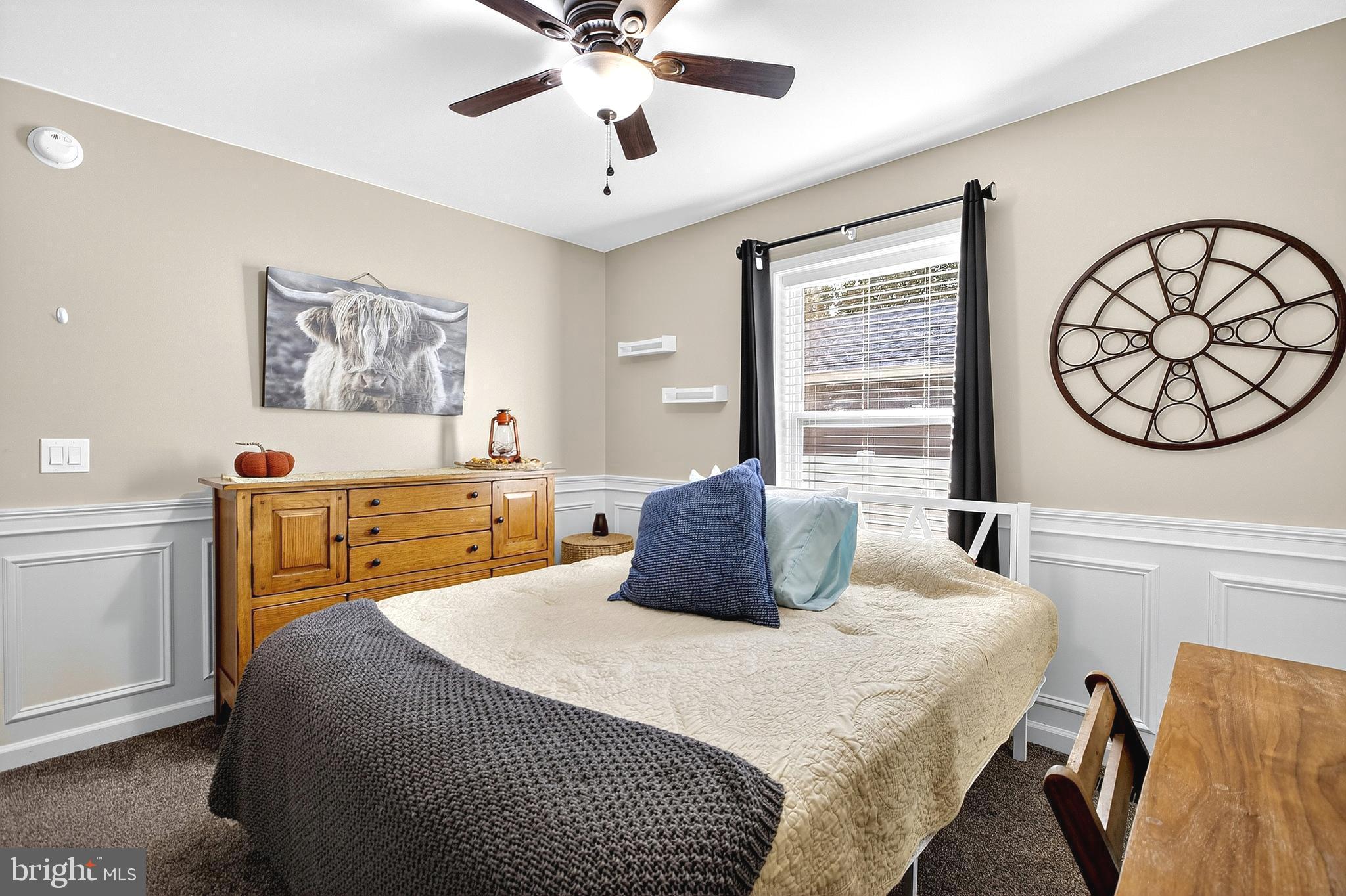 108 West Commerce Street Kenton, DE 19938 - Photo 34 of 48 a bedroom with a large bed and a chandelier