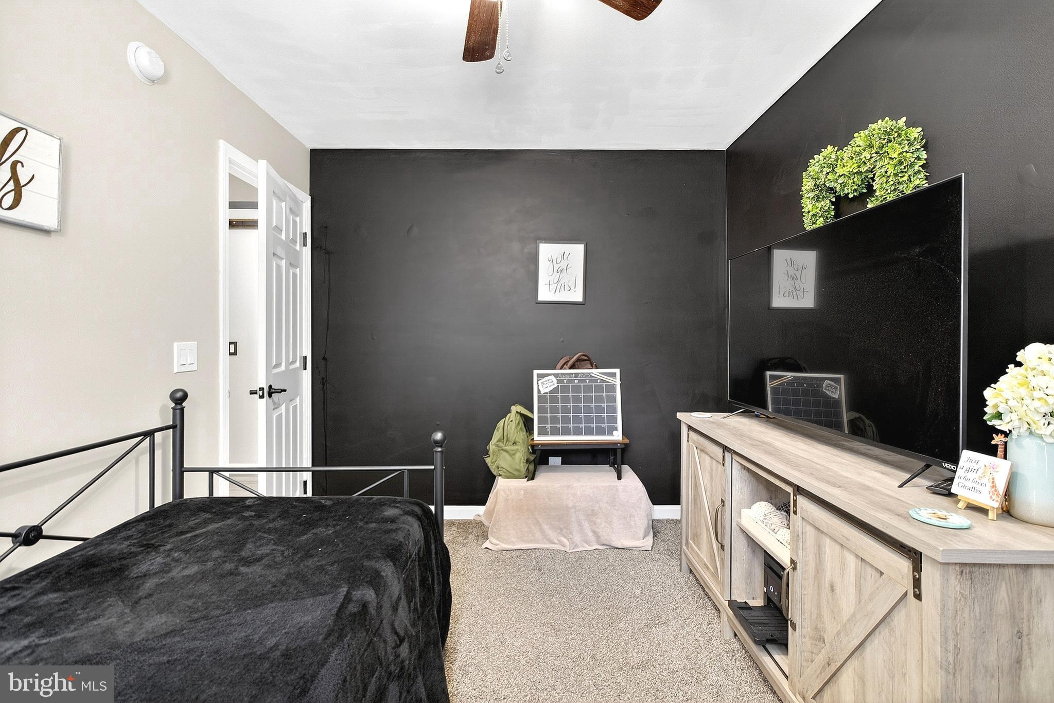 108 West Commerce Street Kenton, DE 19938 - Photo 39 of 48 a bedroom with a bed and a flat screen tv