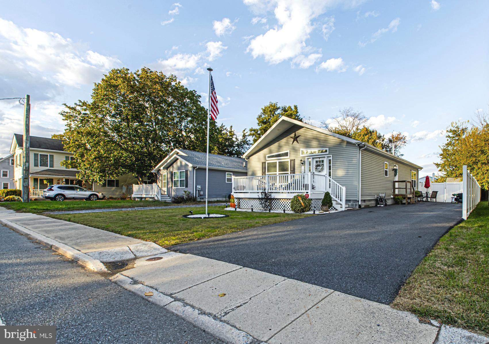 108 West Commerce Street Kenton, DE 19938 - Photo 6 of 48 a front view of a house with a yard and garage