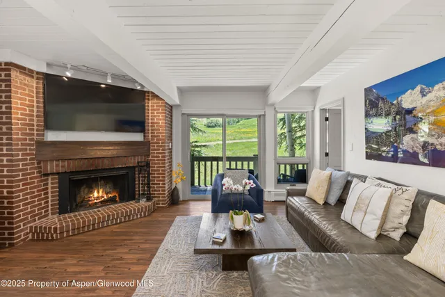 a living room with furniture fireplace and flat screen tv