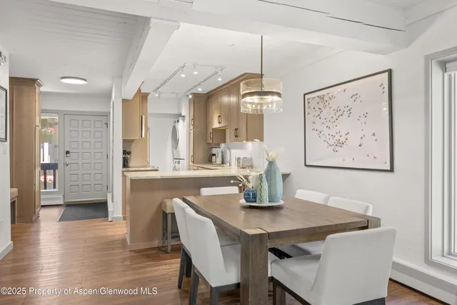 a view of a dining room with furniture and wooden floor
