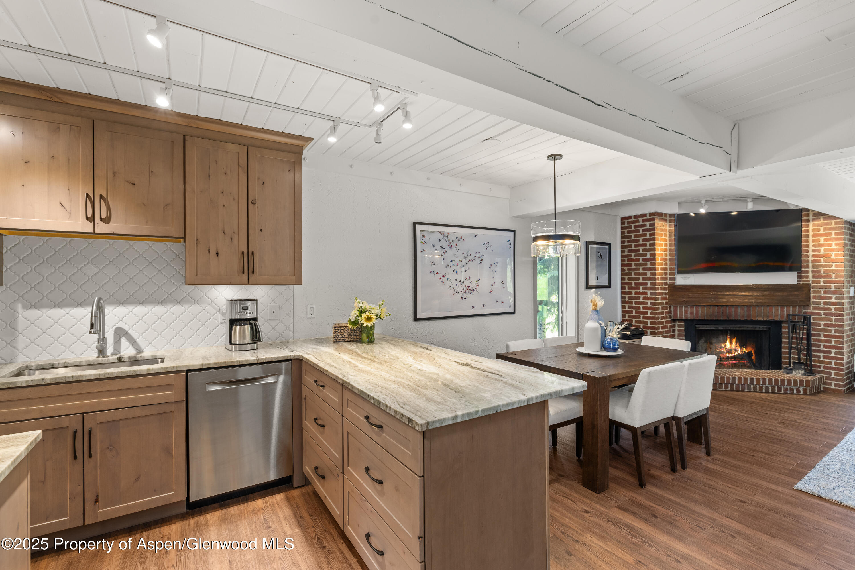 70 Gallun Lane, Unit 206B Snowmass Village, CO 81615 - Photo 8 of 15 a kitchen with a sink stove and cabinets