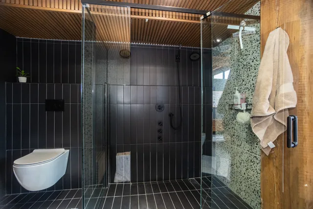 a bathroom with a toilet and a shower