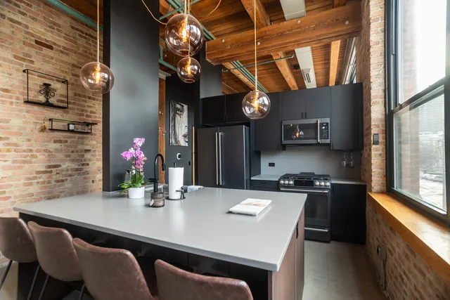 a kitchen with a table chairs stove and cabinets