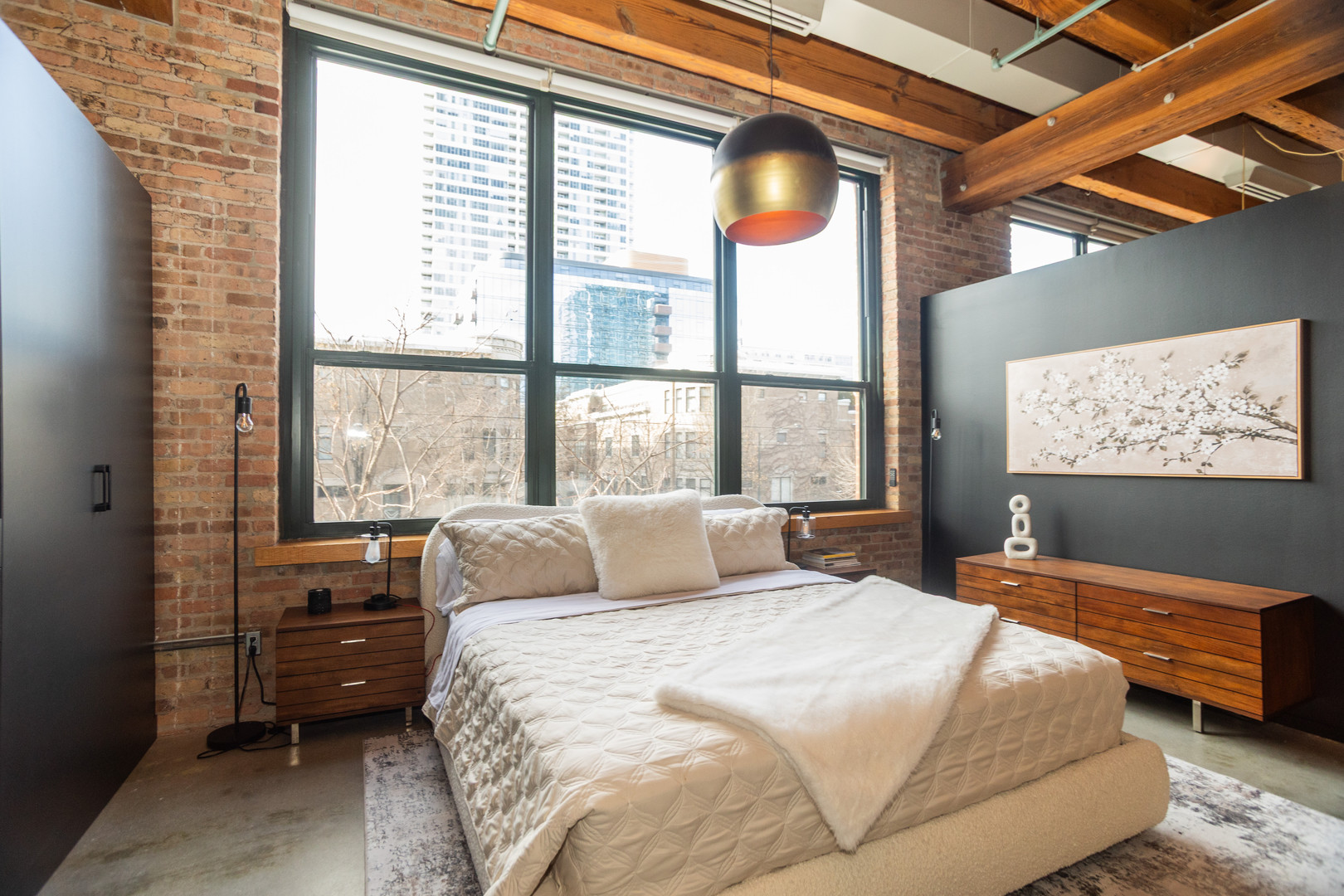 1727 South Indiana Avenue, Unit 201 Chicago, IL 60616 - Photo 8 of 12 a bedroom with a bed and a large window