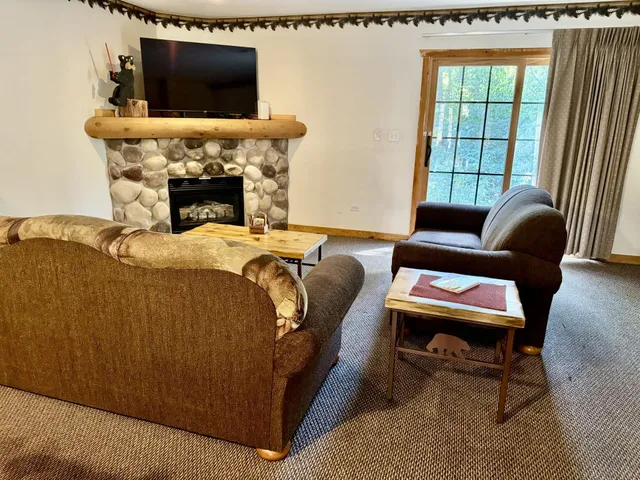a bedroom with furniture and a flat screen tv