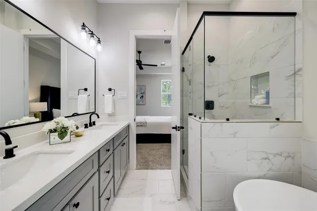 a spacious bathroom with a double vanity sink toilet and shower
