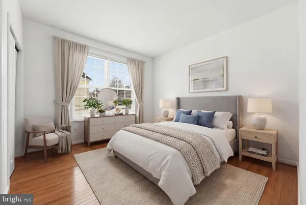 a bedroom with a large bed couch and a window