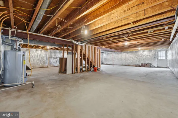 a view of an empty room with wooden ceiling
