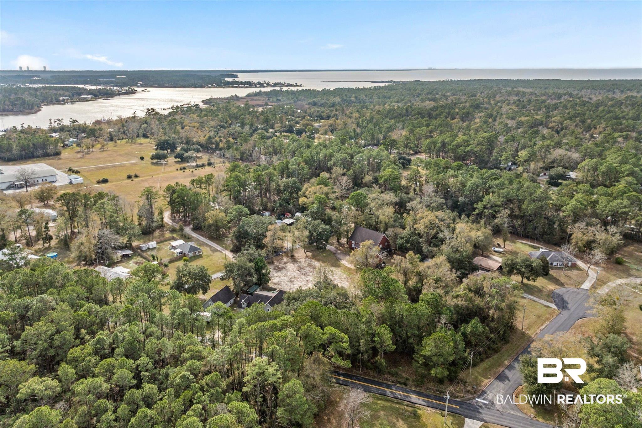 17065 Britt Lane Bon Secour, AL 36511 - Photo 9 of 15 Aerial view of property and surrounding area with a forest and a nearby body of water