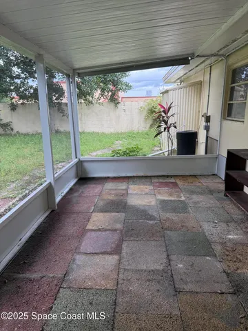 a view of porch with furniture and floor to ceiling window