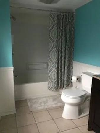 a bathroom with a toilet and a shower