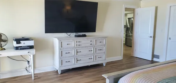 a bedroom with a bed and a flat tv screen