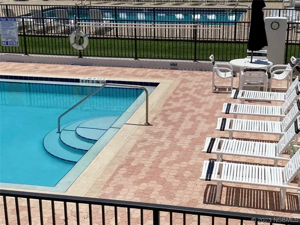 a bedroom with a bed and flat tv screen next to a window