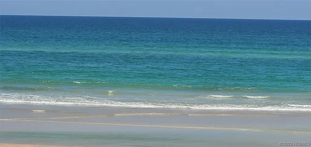 a view of a roof deck with dining table and chair a barbeque with wooden floor