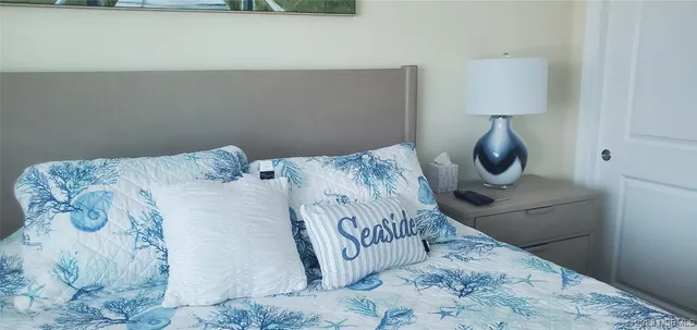 a bed sitting in a bedroom next to a lamp