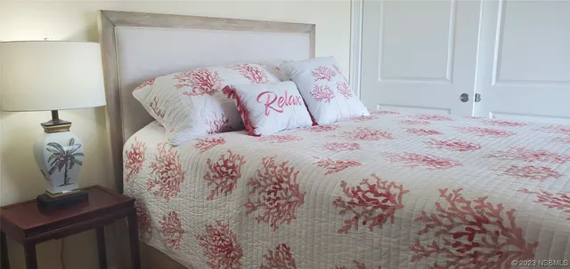 a bedroom with a bed and flat screen tv