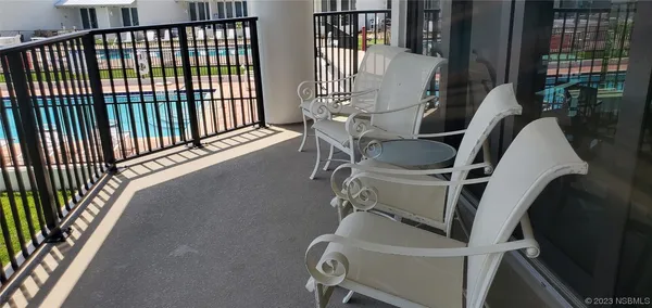 a view of a roof deck with couches and wooden floor