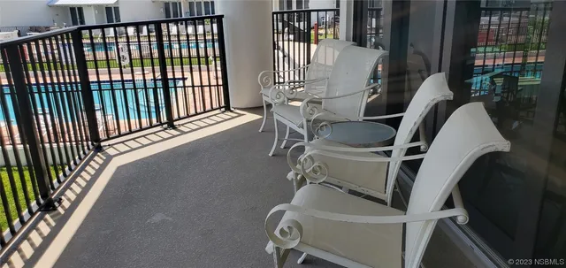 a view of a roof deck with couches and wooden floor