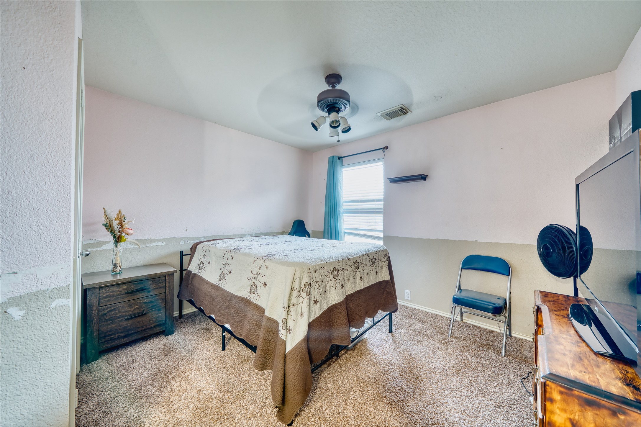 2210 Mountain Ranch Drive Houston, TX 77049 - Photo 28 of 36 a bedroom with a bed a chandelier and a dresser