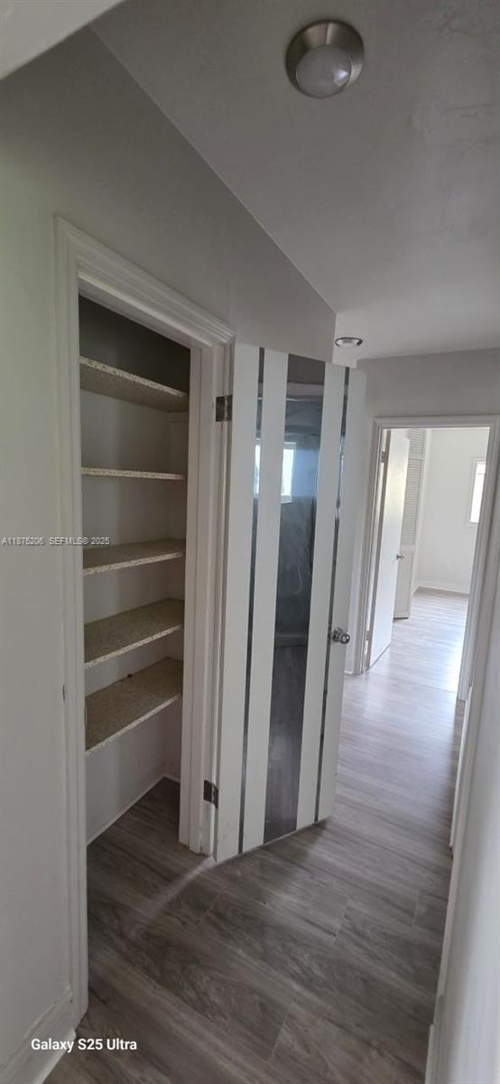 1340 Northwest 133rd Street Miami, FL 33167 - Photo 13 of 31 a view of an empty room with wooden floor and a window