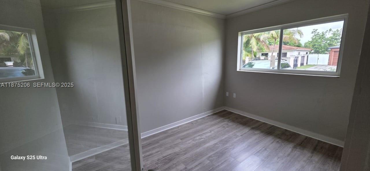 1340 Northwest 133rd Street Miami, FL 33167 - Photo 15 of 31 an empty room with wooden floor and windows