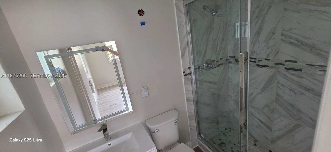 1340 Northwest 133rd Street Miami, FL 33167 - Photo 19 of 31 a bathroom with a shower and toilet
