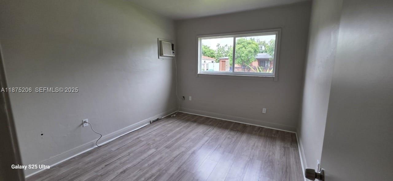 1340 Northwest 133rd Street Miami, FL 33167 - Photo 25 of 31 an empty room with wooden floor and windows
