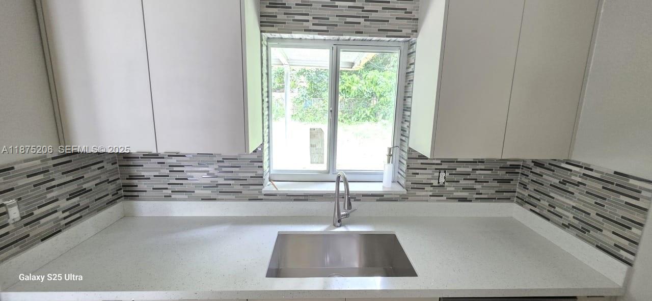 1340 Northwest 133rd Street Miami, FL 33167 - Photo 3 of 31 a kitchen with a sink and a stove