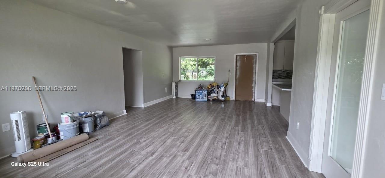 1340 Northwest 133rd Street Miami, FL 33167 - Photo 9 of 31 a view of a room with wooden floor lounge chair and a way to kitchen