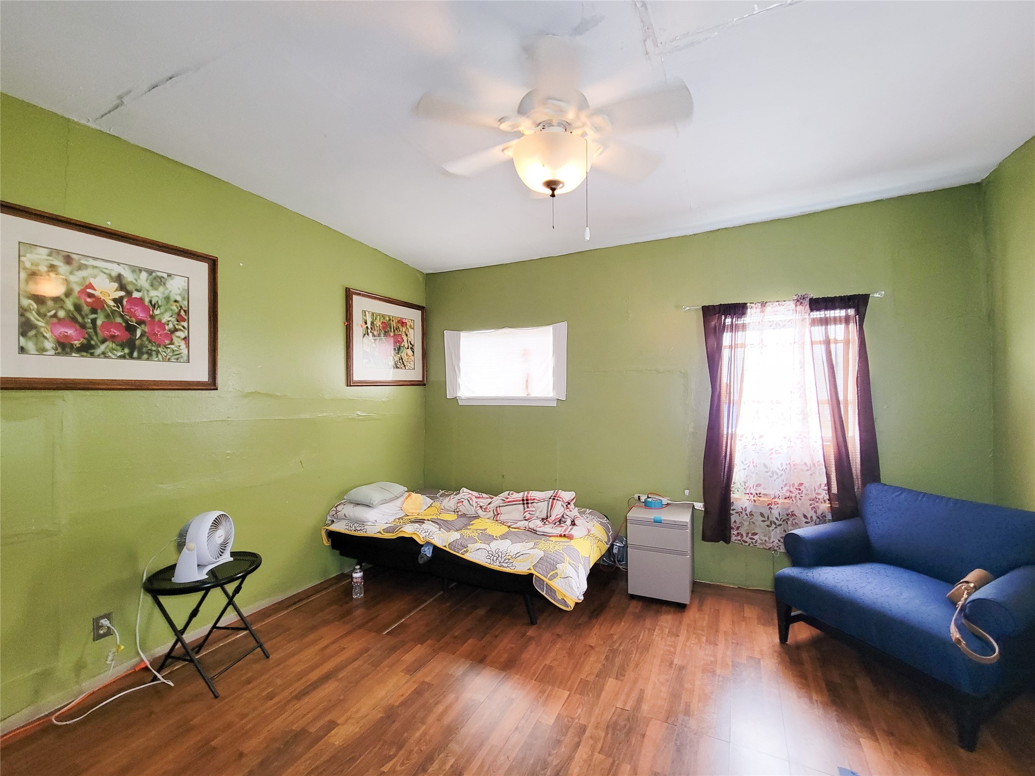 418 Bishop Street Houston, TX 77009 - Photo 18 of 32 a bedroom with a bed and wooden floor