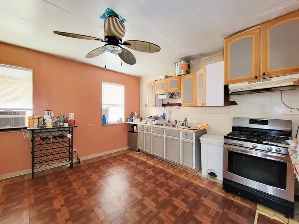 a kitchen with stainless steel appliances a stove a sink and cabinets