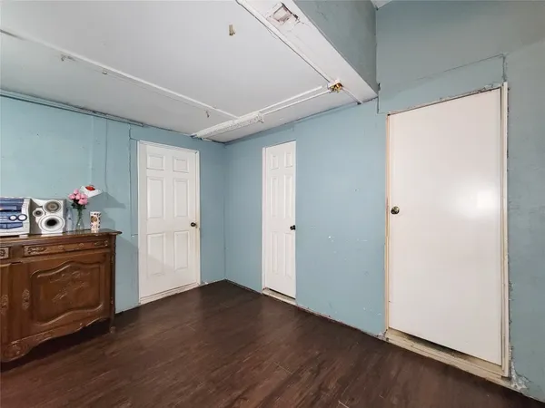 a view of a kitchen with wooden floor and electronic appliances