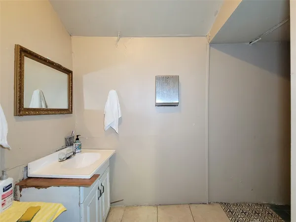 a bathroom with a sink vanity and a mirror