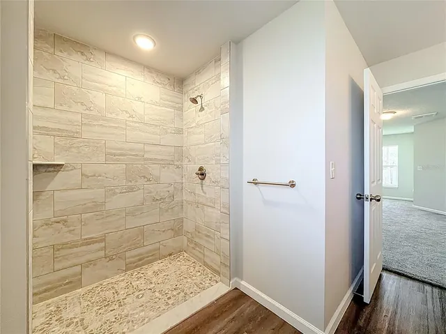 an empty room with closet and windows